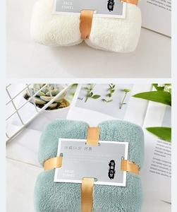 Detailed macro view of soft coral fleece face towels in cream and grey blue gift set