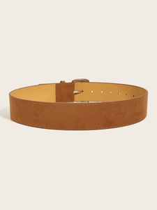 Detail of vintage brown wide suede belt featuring a classic metallic pin buckle closure