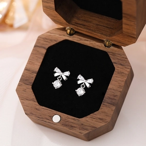 Elegant S999 sterling silver bow earrings with sparkling zircons in a premium wooden box
