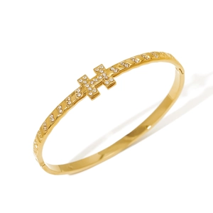 Luxurious gold H-shaped bangle with sparkling zircon pavé and spiral textured band