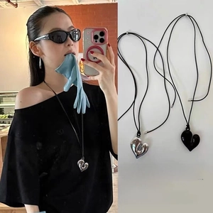 Detail of a minimalist 3D puffy heart pendant with adjustable black cord necklace