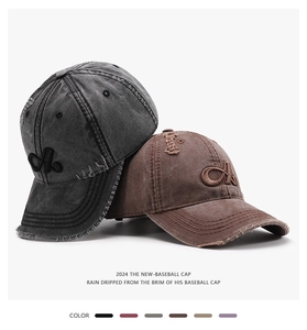 Close-up of distressed washed cotton baseball caps with 3D letter A embroidery details