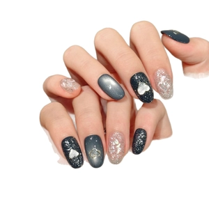 Cool style black heart press-on nails with silver glitter and cat eye effect on white background