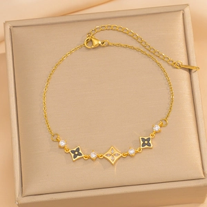 Elegant gold chain bracelet featuring zircon flowers and black enamel charms for women