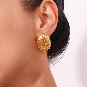 Close-up of 18K gold plated stainless steel stud earring with textured granular surface