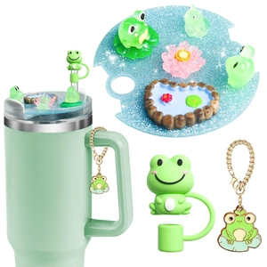 Detail of frog-themed 40oz tumbler accessories with lid plate, straw cover and keychain