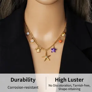 Detail of golden ocean-themed necklace with starfish, turtle and shell charms on model