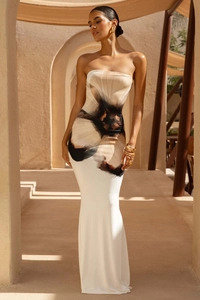 Detailed view of white bodycon maxi dress with large brown floral print in natural light