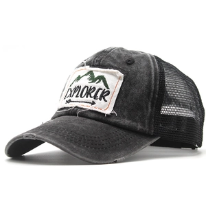 Close-up of distressed vintage mesh trucker hat with Explorer mountain embroidery