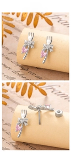 Detail view of silver bow stud earring featuring a pink heart-shaped gem and screw back