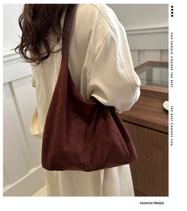 Detailed view of deep brown faux suede hobo bag with soft texture and leather strap