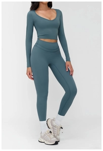 Front view of foggy blue two-piece yoga set with long sleeve crop top and leggings
