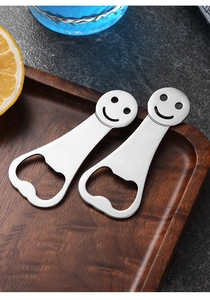 Macro shot of creative stainless steel bottle openers with smiley faces on a wooden tray