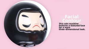 Macro detail of the 3D contoured face on this Japanese Daruma electric piggy bank
