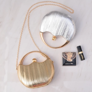 Elegant gold and silver circular evening bags with metallic texture and round ring handles
