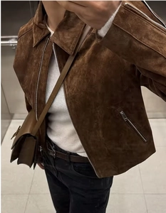 Detailed close-up of a brown suede biker jacket featuring a stylish lapel and zip closure
