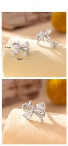 Detail view showing silver bow earrings with shiny crystals and screw back closure