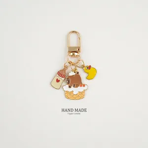 Close-up of alloy Capybara keychain featuring a brown water pig and a yellow duck charm