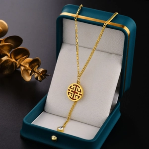 18K gold plated titanium steel necklace with a round openwork pendant and crystal drop