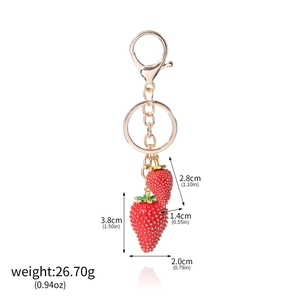 Detailed view showing dimensions and weight of red strawberry fruit keychain pendants