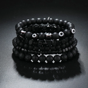 Detail view of multi-layer beaded bracelets with lava rock and protective eye charms