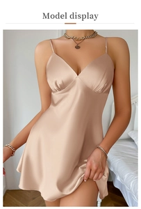 Detailed view of champagne silk slip dress with deep V-neck and delicate pleats