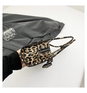 Top view of leopard print handbag showing zipper closure and heart-shaped charm detail