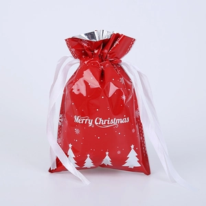 Close-up of red Christmas drawstring gift bag with white snowflake and tree patterns