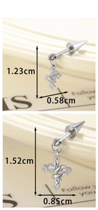 Macro view showing dimensions of silver zircon star cross ear piercings in punk style