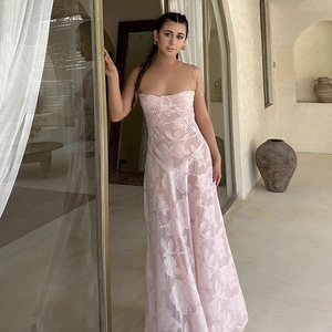 Detail of pink floral embroidery and semi-transparent texture on a slim evening gown