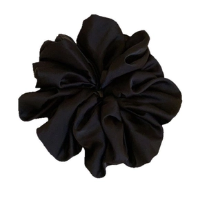 Elegant oversized black satin scrunchie with voluminous ruffles for stylish hair styling