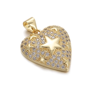 Detail of a gold-plated heart pendant with star engraving and sparkling crystals