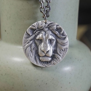 Silver lion head pendant necklace with vintage embossed design and metallic chain link
