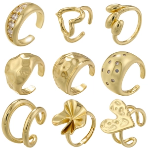 Nine piece set of gold geometric open rings and ear cuffs with zircon and hammered finish