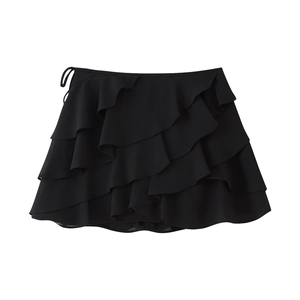 Detail of black tiered ruffle mini skirt showing lightweight fabric and side tie closure