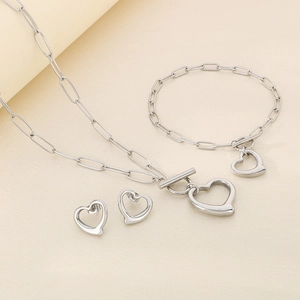 Three-piece silver jewelry set featuring hollow heart pendants and OT clasp details