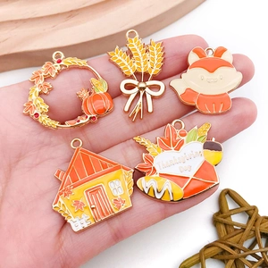 Five assorted Thanksgiving charms including pumpkins and foxes with Thanksgiving Day text