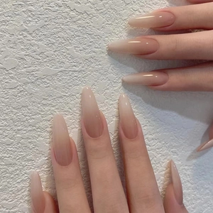 Long almond ombre press-on nails in nude pink to soft white with high-gloss finish