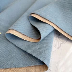 Macro shot of blue and beige double-sided cashmere-like scarf with twill texture