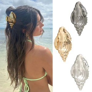 Detail of gold and silver conch shell hair claws for beach vacations and summer styling