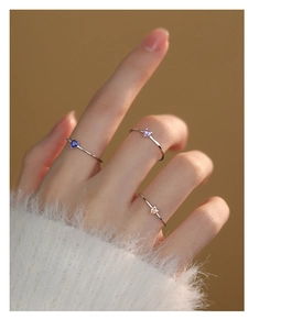 Detailed close-up of three slender S925 silver rings with colorful heart-shaped zircons