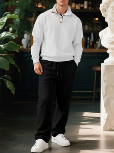 Detail of men's ribbed knit sweater with elbow patches and matching casual trousers