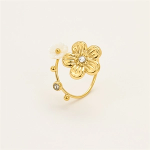 Detailed macro view of 18K gold floral ring featuring white shell petals and sparkling zircon
