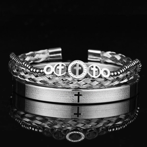 Detailed view of silver stainless steel bracelets with cross charms and Padre Nuestro text