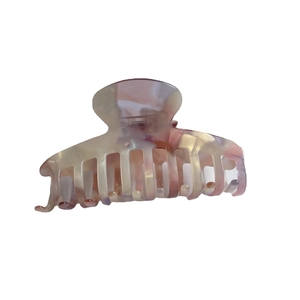 Elegant acetate claw clip with pink and white marble pattern on a clean white background