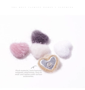 Detail of plush heart-shaped magnetic charms showing soft texture and back magnets