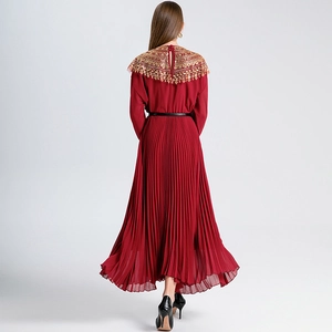 Pleated red maxi dress with gold sequin shoulder embroidery and flowing chiffon hemline