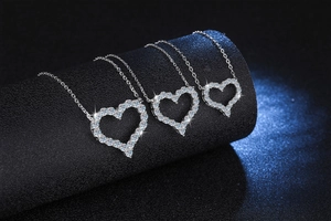Detailed comparison of three heart-shaped pendants in various sizes with diamond pave settings