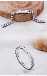 Macro shot of 316L stainless steel bracelet with diamond cross and vintage carving