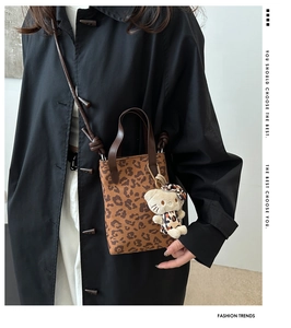 Fashionable leopard print handbag with matching kitty charm and crossbody strap